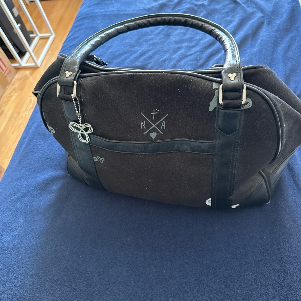 TNA Black Canvas Travel Tote with Leather Trim and Charm
